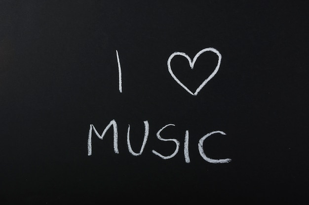 Free photo i love music text written with chalk on blackboard