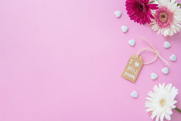 I love you mom inscription with gerbera flowers on table