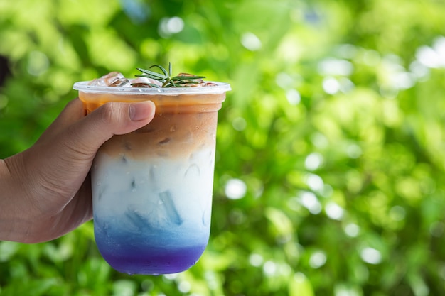 Ice butterfly pea latte on wooden surface