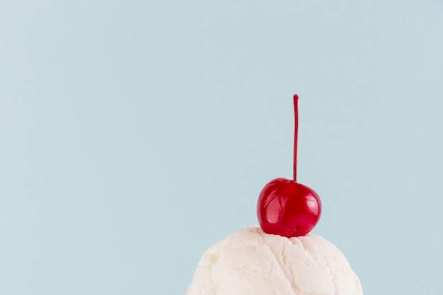 Ice cream ball with juicy cherry above