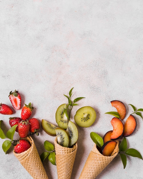 Free Photo ice cream cones with fresh fruits