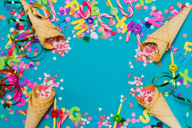 Ice cream cones with hearts and confetti on a blue background