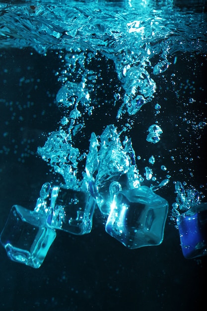 Ice cubes with bubbles underwater