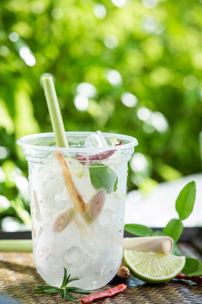 Ice herbal tea on wooden surface