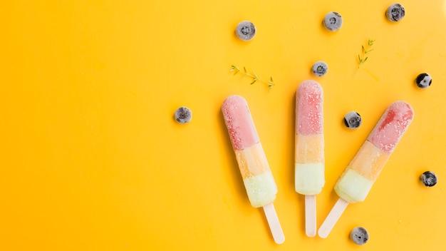 Ice lollies near blueberries