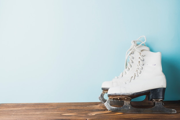 Ice skates near blue wall