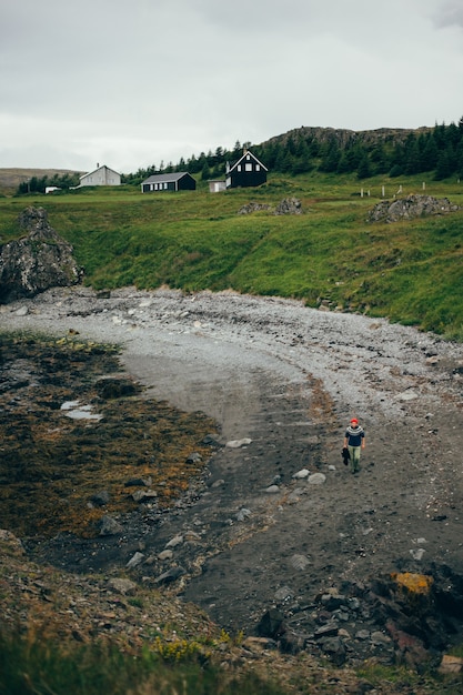 Icelandic beach scenery, man walks in sweater