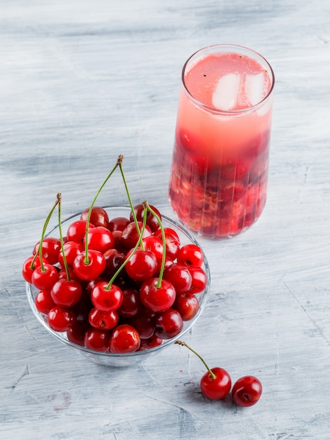 Free photo icy cherry drink in a jug with cherries high