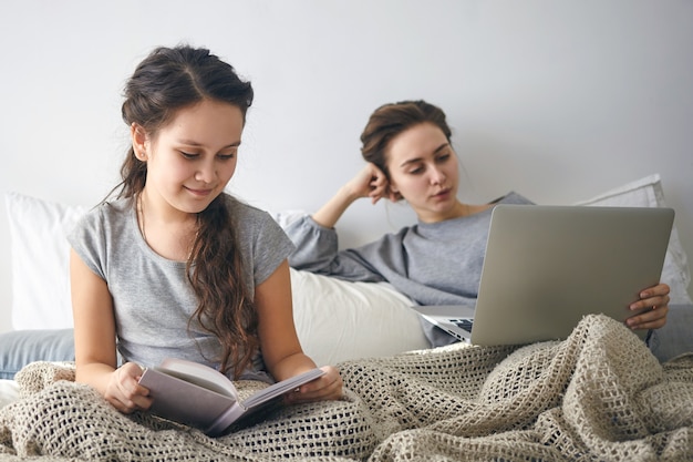 Ideal cozy picture of charming 10 year old female child enjoying favorite fairytale