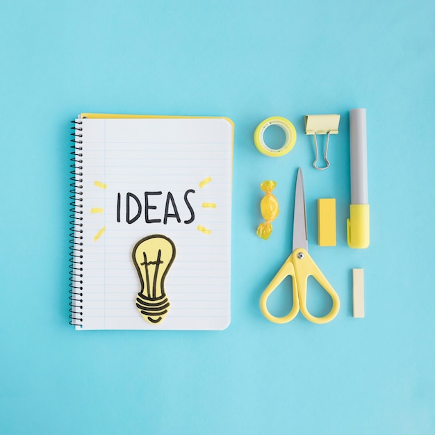 Free Photo ideas light bulb with stationary on blue background