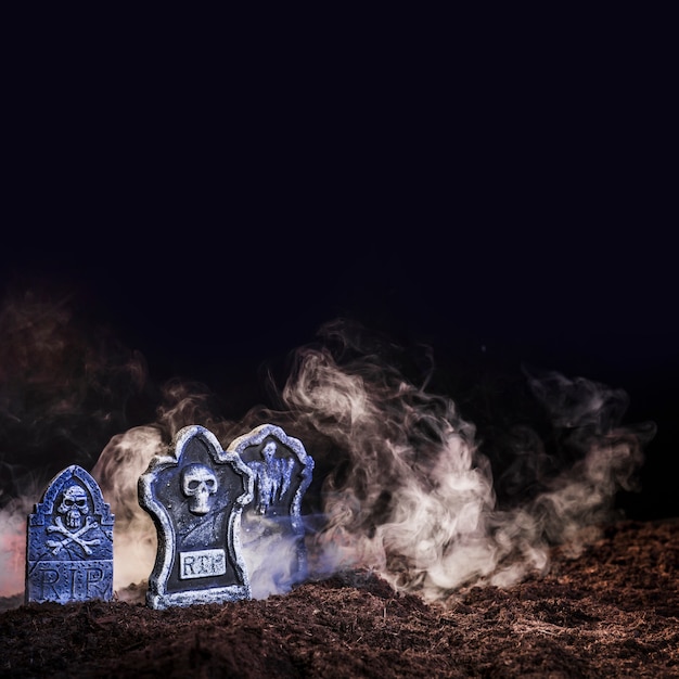 Free Photo illuminated gravestones between fog on ground