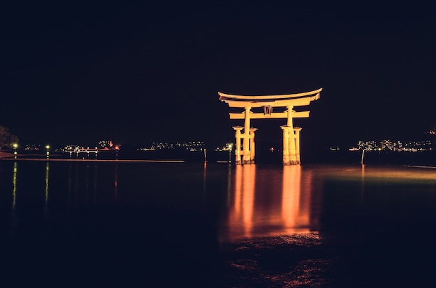 Illuminated Itsukushima Floating Torii Gate at night, Miyajimacho, Japan