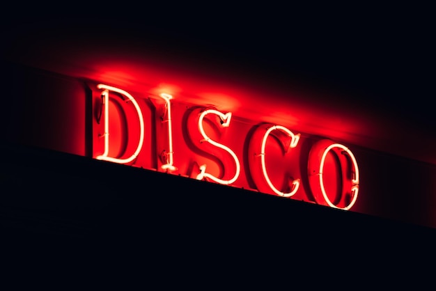 Free photo illuminated red signboard of disco