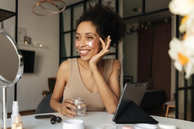 Image of african beauty woman look at mirror with patches