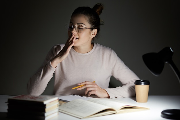 Image of attractive seepy student yawns with closed eyes