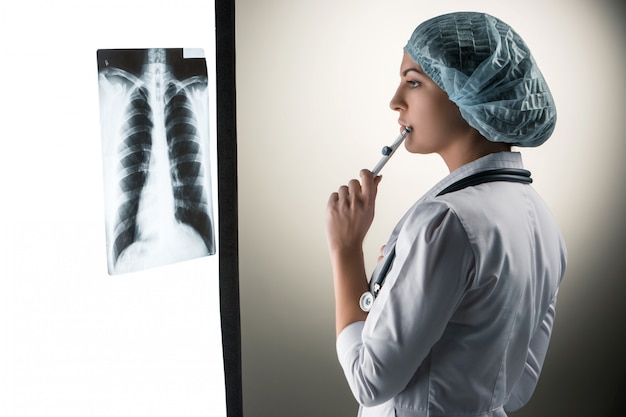 Free photo image of attractive woman doctor looking at x-ray results