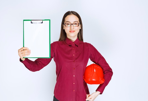 Free photo image of beautiful woman in glasses holding crash helmet with folder.