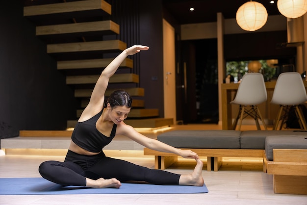 Image of brunette young woman stretching at home