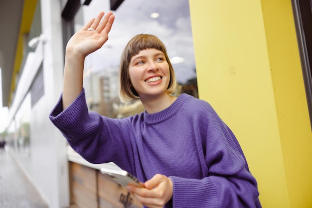 Image of caucasian woman waving hand