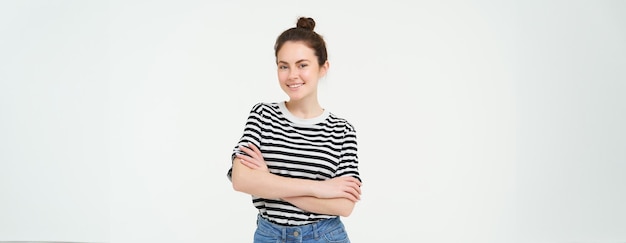 Free photo image of charismatic young woman in striped tshirt and jeans looking confident and happy smiling at