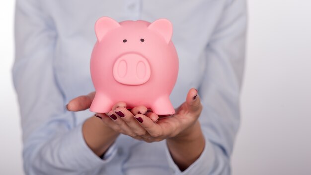 Image of pink piggy bank held by female