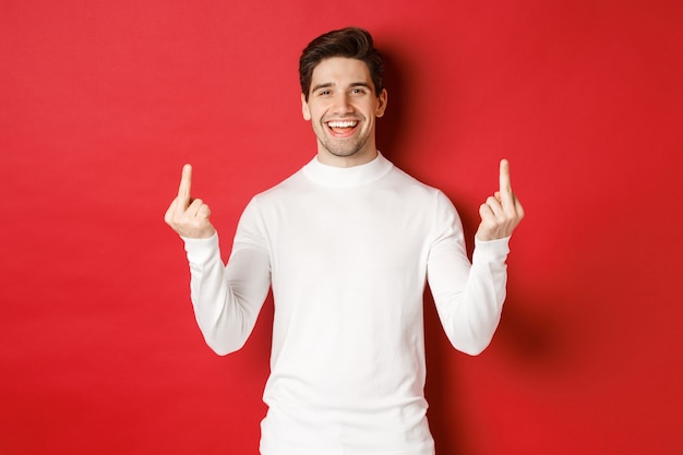 Image of rude and unbothered man laughing while showing middlefingers telling to fuckoff standing ov...