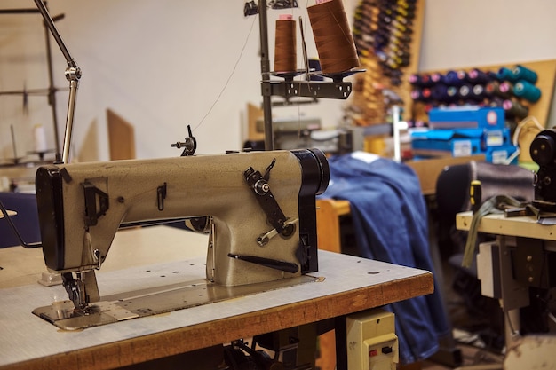 Image of a tailor's workplace with a sewing machine at the sewing workshop.