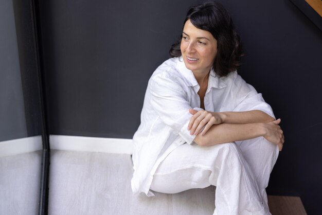 Image of woman looking away sit in the stairs