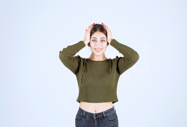 Free photo image of a young beautiful woman model holding her head