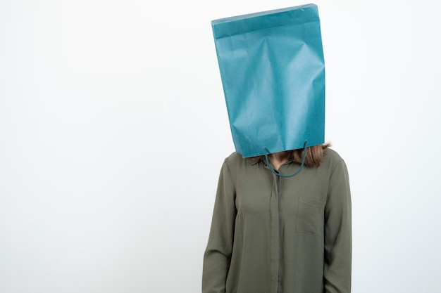 Image of young girl getting her head inside of craft bag. High quality photo