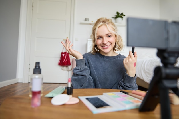 Free Photo image of young stylish woman blogger recording a beauty lifestyle video of her picking best lipstick