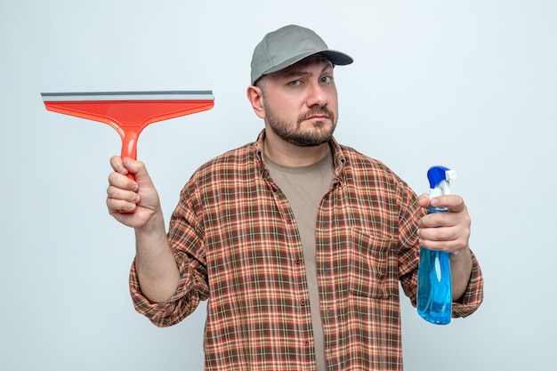 Free Photo impressed cleaner man holding squeegee and spray cleaner 