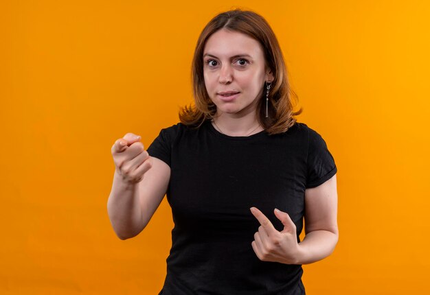 Impressed young casual woman pointing  and herself on isolated orange space with copy space