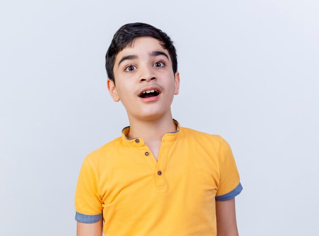 Impressed young caucasian boy looking at camera isolated on white background