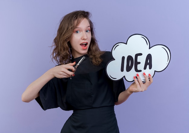 Free Photo impressed young slavic female barber wearing uniform holding idea bubble and scissors isolated on purple background