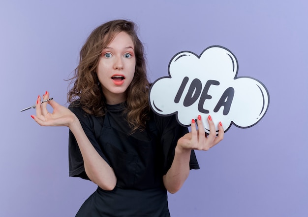 Free Photo impressed young slavic female barber wearing uniform holding scissors and idea bubble isolated on purple background