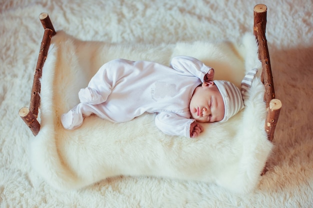 Incredible and sweet newborn baby sleeps on the bed