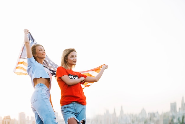 Independence day concept with girls standing on rooftop