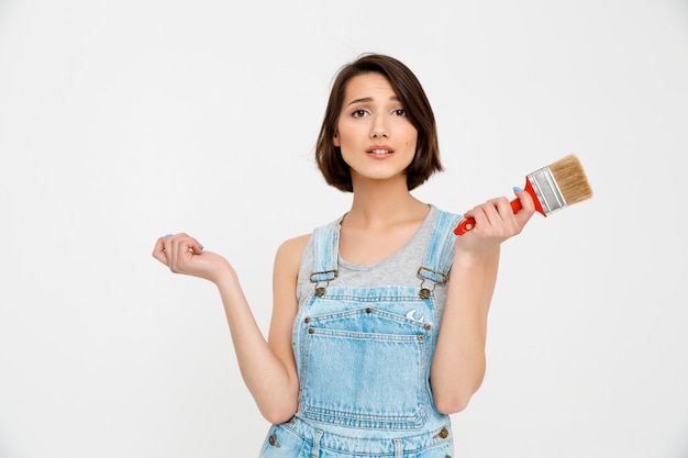 Independent woman do repair at home herself, hold painting brush