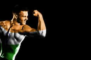 Free photo india flag on handsome young muscular man black background