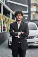 Free photo indian businessman near his car