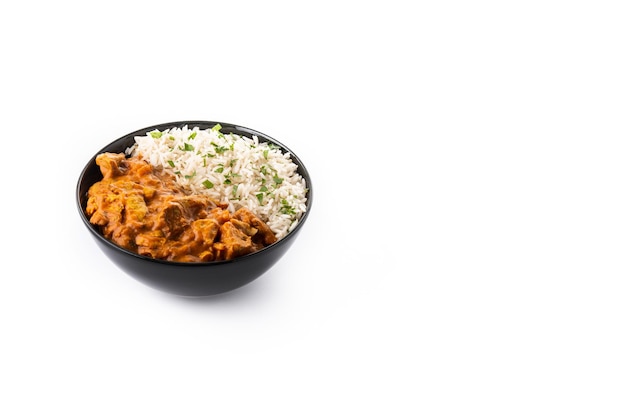 Indian butter chicken in black bowl isolated on white background