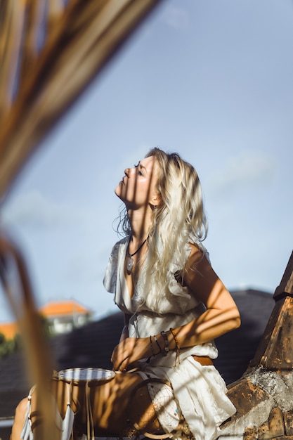 Free Photo indian girl on the roof. dream catchers. beautiful blonde girl with dream catchers.