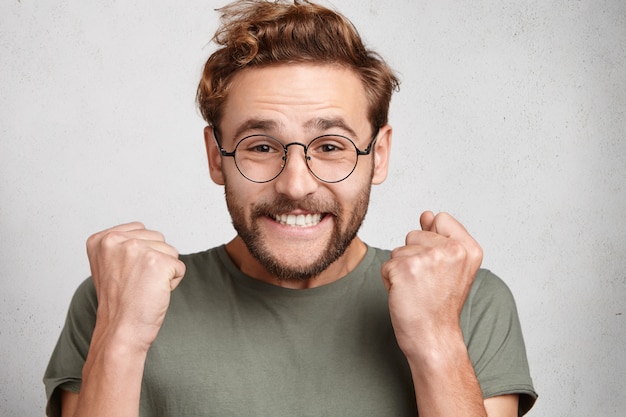 Free Photo indoor portrait of bearded young man with trendy hairstyle