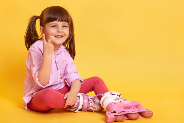 Indoor shot of happy girl sitting on floor