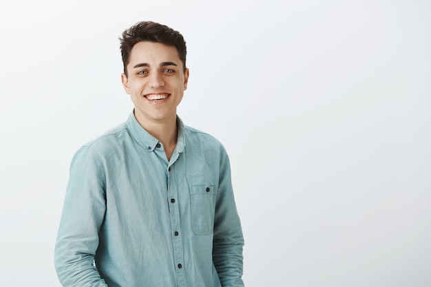 Free photo indoor shot of positive outgoing male friend in casual shirt