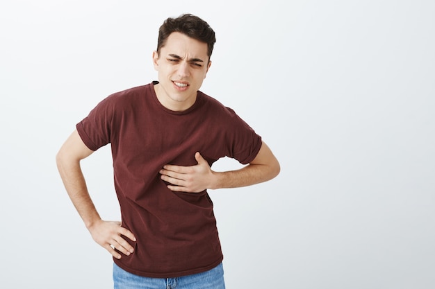 Free Photo indoor shot of suffering caucasian guy in red t-shirt