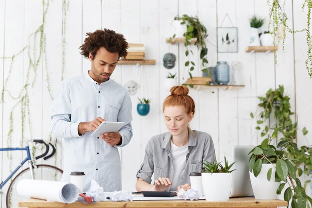 Indoor shot of two architects working together on common construction project