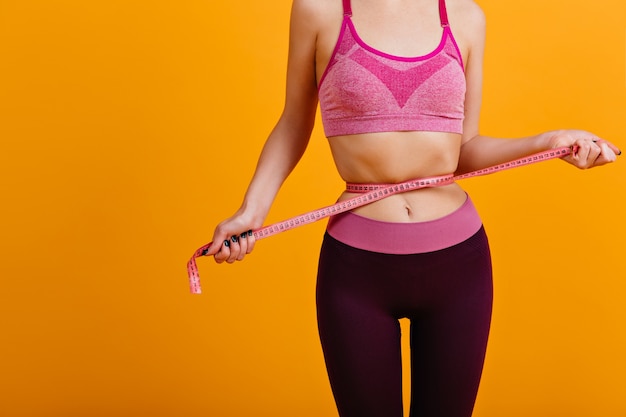 Indoor shot of woman in good shape after diet