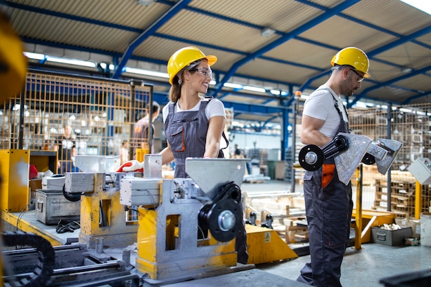 Industrial employees working together in factory production line